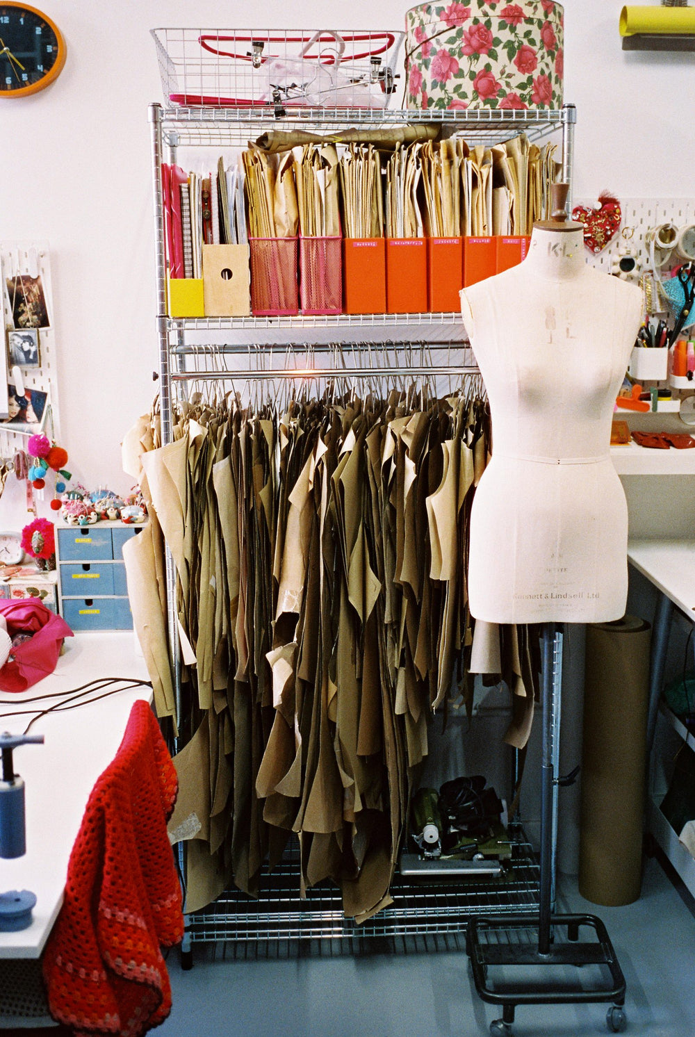 Dress form and rail of brown paper garment patterns in the Totty Rocks studio