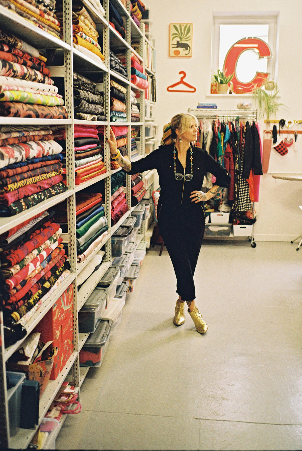 Holly Campbell among shelves of colourful fabric in the Totty Rocks studio, Edinburgh
