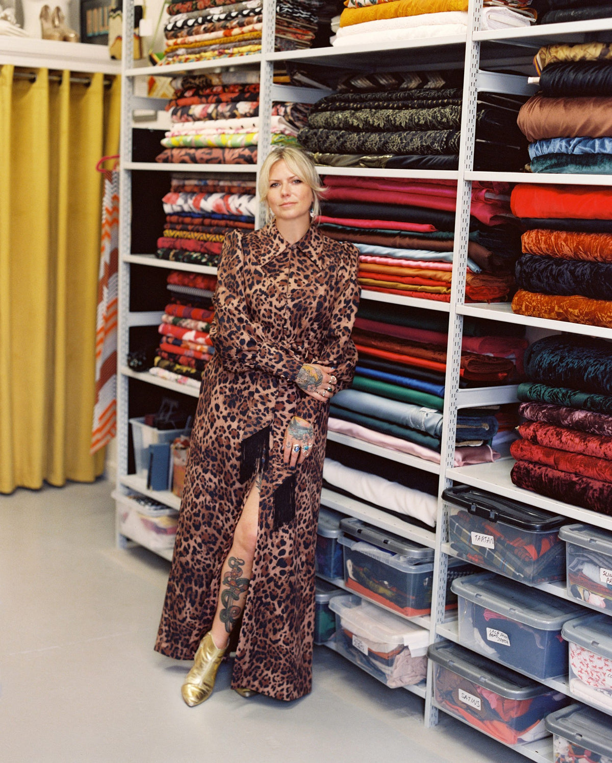 Holly Campbell in a leopard-print maxi dress in front of her fabric shelves