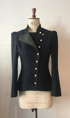 A 2-tone fencing jacket displayed on a mannequin, with contrasting front-facing panels in a different color and gold buttons.
