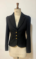 A tailored Missy DuPont jacket displayed on a mannequin, featuring a cutaway rever collar and tuck shoulder detail.