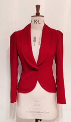 A red show jacket displayed on a mannequin, featuring a shawl collar, single-button closure, and a half-belt design.