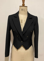 A black tailcoat displayed on a mannequin, featuring a traditional design with strong shoulders and a dramatic silhouette.