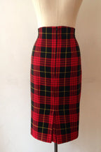 A high waisted, knee-length pencil skirt with a red and black tartan pattern, displayed on a mannequin.